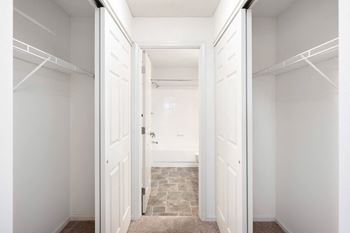 A closet in a bedroom with white doors